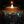 A lit amber glass jar candle with a white wick and a dark forest-themed label reading 'LAST LOOKS GROOMING CO presents ALMOST BIRTHDAY GIRL' in red text.